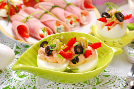 eggs stuffed with tuna spread and olives as appetizer for easter breakfastの写真素材