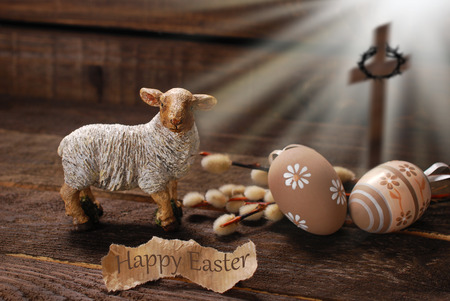 easter concept with cross in light rays and lamb as a symbol of  sacrifice offered to Godの写真素材