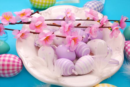easter eggs in white plate on blue background