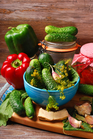 fresh cucumbers and peppers ready for pickles on wooden backgroundの写真素材