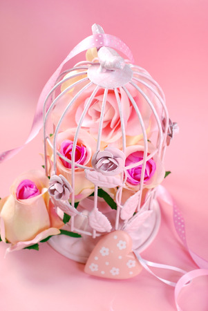 roses romantic pink flowers in a metal cageの写真素材