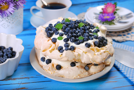 blueberry pavlova cake on blue wooden tableの写真素材