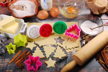 ingredients and utensils for baking Christmas cookies on rustic wooden tableの写真素材
