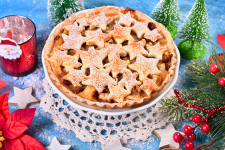christmas homemade apple pie with star shape decoration and icing sugarの写真素材