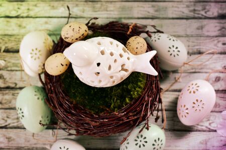 easter decoration with eggs and ceramic bird in nest -top viewの写真素材