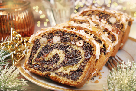 sliced poppy seed cake with nuts and raisins for christmasの写真素材