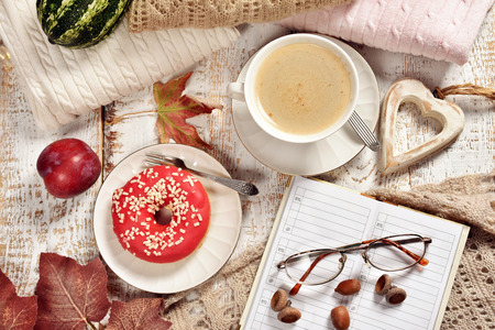 autumn flat lay with coffee,donut,planner and warm sweatersの写真素材