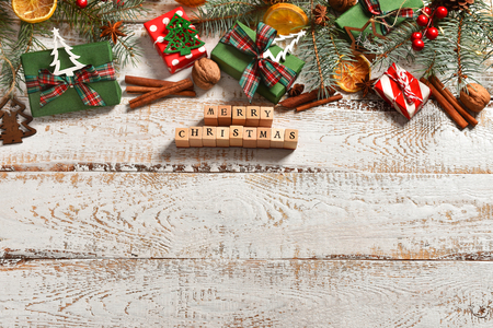christmas flat lay background on white wooden board with fir branches and decorations on the top and space for own textの写真素材