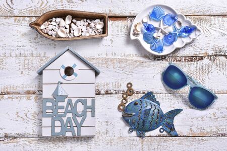 summer holidays flat lay with marine decors lying on white wooden background