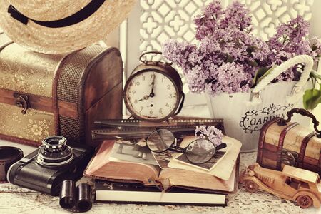 vintage style still life with old photographs, camera, films, clock and wooden chestsの写真素材
