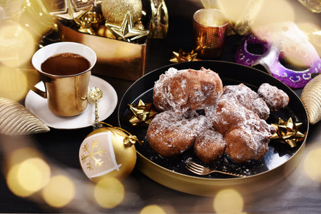 homemade donuts sprinkled with icing sugar in Poland called racuchy and coffee for carnival partyの写真素材