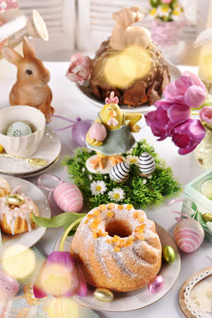 traditional Easter ring cake sprinkled with icing sugar on festive table