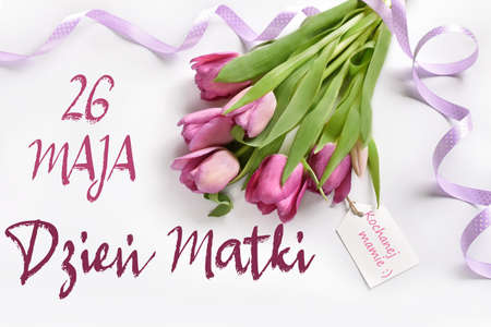 flat lay with bunch of pink tulips for mom lying on white background with text in polish language