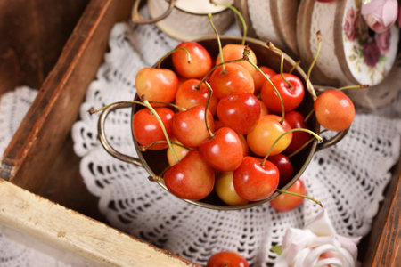 still life of fresh yellow and red sweet cherries in rustic styleの写真素材