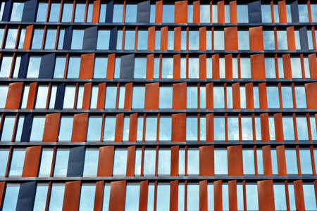 abstract texture background of modern building fasade made of red metal and glass