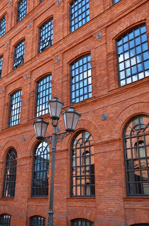vintage style street lantern in front of old brick factory building in Lodzのeditorial素材