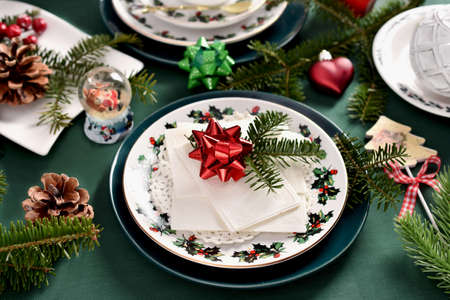 Traditional Polish Christmas Eve wafer on decorative plate on festive table with green tableclothの写真素材