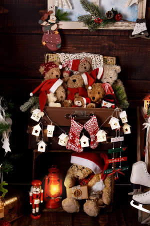 Vintage style Christmas decorations with teddy bears in old suitcase, lantern and ornamentsの写真素材