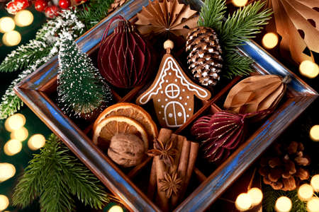 wooden shadow box with collection of handmade paper ornaments, miniature Christmas tree and traditional spicesの写真素材
