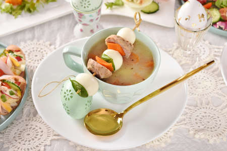 traditional Easter white borscht with quail egg, carrot and sausage skewerの写真素材