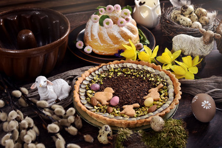 Traditional Polish Easter cake mazurek with chocolate glaze and pistachio and ring cake on wooden table in rustic styleの写真素材