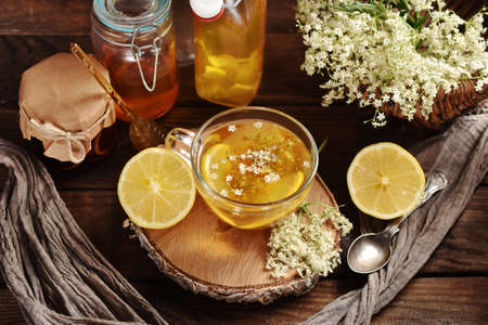 Glass of healthy elderberry blossom tea with honey and lemon for cold and immunityの写真素材