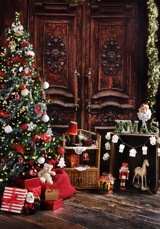 Christmas background with Christmas tree and vintage style decors with old wooden doorsの写真素材