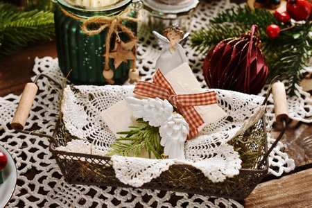 Traditional Christmas Eve wafer lying on lace napkin and hay in vintage style basketの写真素材