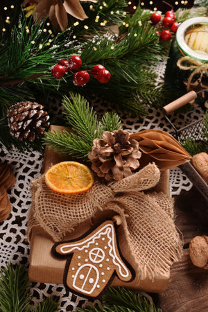 Gift wrapped in a rustic style with creative handmade decorations on a wooden tableの写真素材