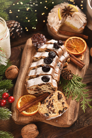 Sliced stollen cake on wooden board for Christmas on rustic style table top viewの写真素材