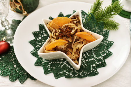 Traditional sweet dessert for Christmas Eve's super with noodles, poppy seeds, raisins and dried fruits in star shaped bowlの写真素材