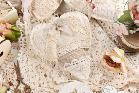 Vintage style handmade hearts sewn with linen and laces on the tableの写真素材