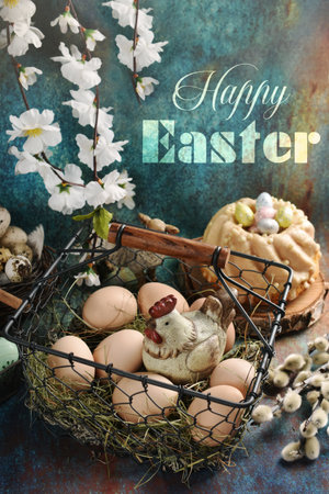 Vintage style Easter table with eggs and a hen figurine in wire basket and ring cake on grunge background with wishes textの写真素材
