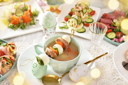 Top view of Easter table with traditional Polish dishes-white borscht, stuffed eggs and saladsの写真素材