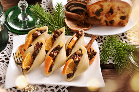 Sweet dessert with shell shaped noodles filled with poppy seeds, dried fruits and nuts and traditional Polish pastriesの写真素材