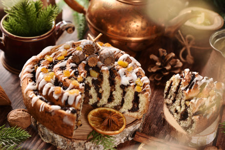 Round zebra poppy seed cake with icing and orange peels for Christmas on rustic style tableの写真素材