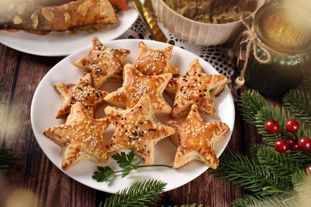 Star shaped puff pastry pies with mushroom filling and sesame topping for Christmas Eve's supperの写真素材