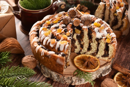 Round zebra poppy seed cake with icing and orange peels for Christmas on rustic style tableの写真素材