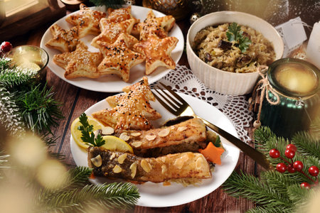 Fried carp with almond flakes, sauerkraut with mushrooms and star shaped puff pastry pies filled with mushrooms for Christmas Eve's supper in Polandの写真素材