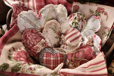 A basket full of vintage style handmade heart decors made of various old fabricsの写真素材