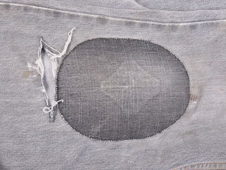 Old torn grunge vintage denim jeans trousersの写真素材