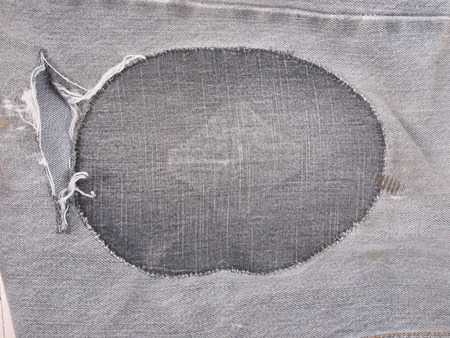 Old torn grunge vintage denim jeans trousersの写真素材
