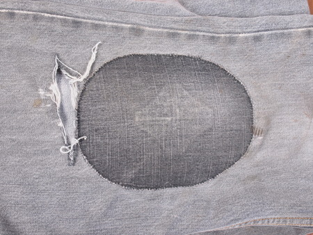 Old torn grunge vintage denim jeans trousersの写真素材