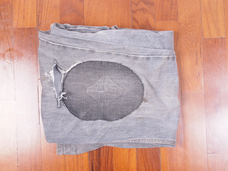 Old torn grunge vintage denim jeans trousersの写真素材