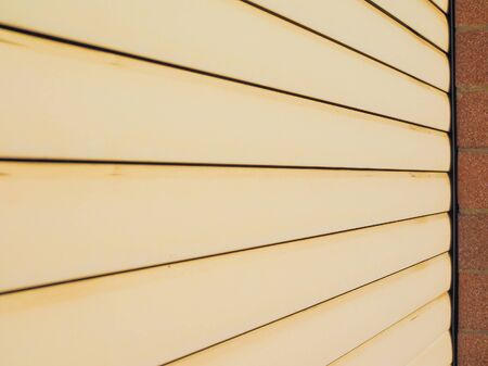 Yellow plastic rolling shutter useful as a backgroundの写真素材