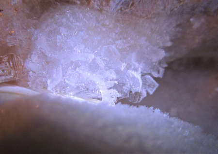 Macro image of a small piece of ice with different shapes and sizes of frozen crystals.の写真素材