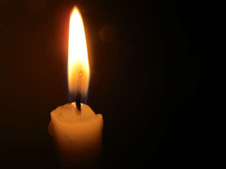 Candle lits in the dark of the night.の写真素材
