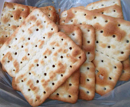 Crispy and toasted saltine crackers in the bottom of a bowlの写真素材