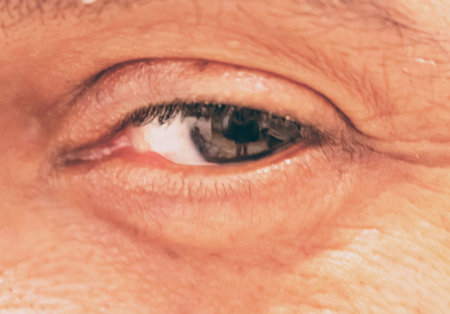 Closeup of male gauze with photographer's image on man's iris.の写真素材