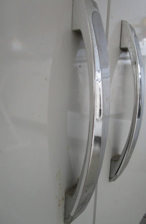 Close-up of two cabinet door handles.の写真素材